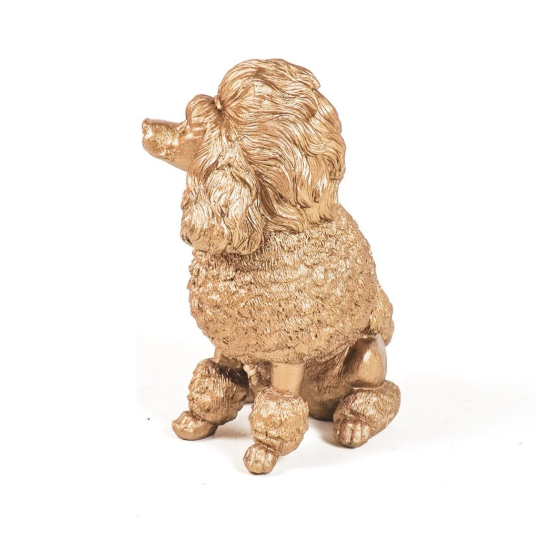Gouden beeldje van een poedel als aandenken aan overleden hond

