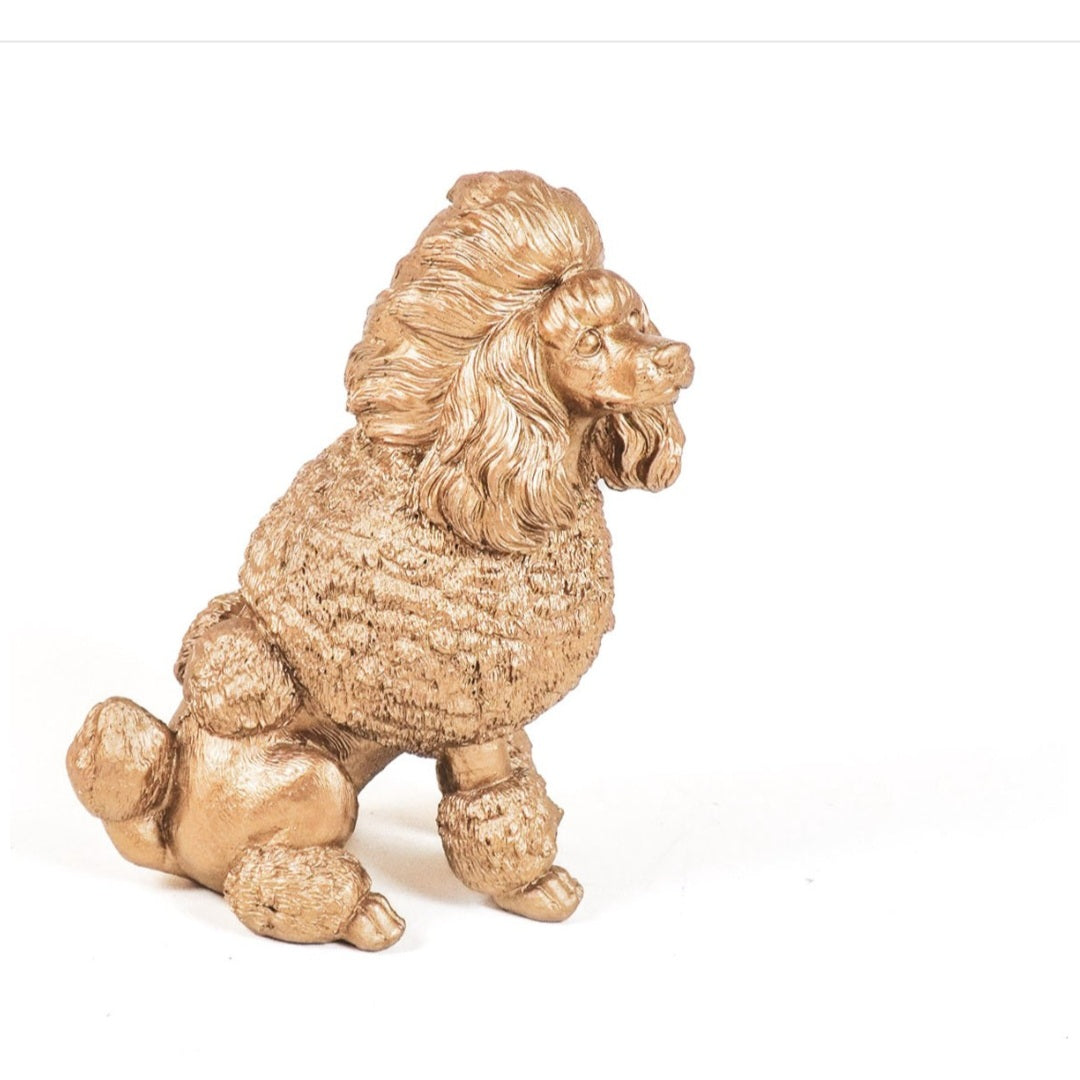 Gouden beeldje van een poedel als aandenken aan overleden hond

