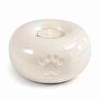 Ronde urn hond of kat in beige, detail pootafdruk en waxinelicht
