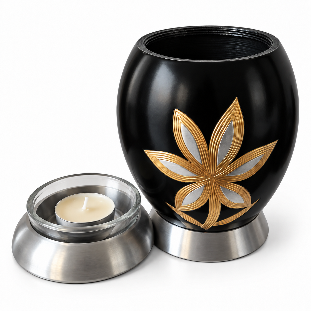 De laatste aai zwarte aluminium mini urn met goud-zilveren lelie motief en glazen waxinelichthouder voor asbewaring.