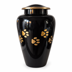 De laatste aai zwarte aluminium urn voor huisdieren met gouden pootafdrukken en een elegant deksel.