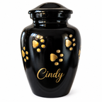 De laatste aai zwarte aluminium dierenurn met handgelegde gouden pootafdrukken en gepersonaliseerde naam Cindy.
