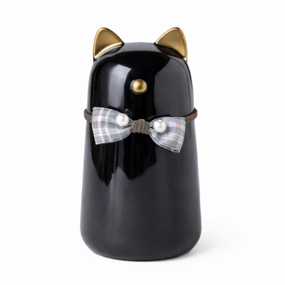 Urn in de vorm van een kat - gemaakt van zwart keramiek, met goudkleurige details en is voorzien van een schattig strikje